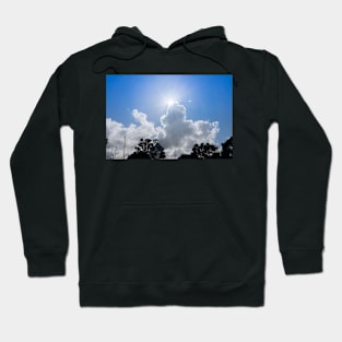 Sun bursts above cloud against blue sky. Hoodie